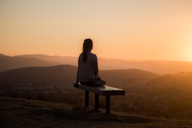 Woman sitting watchin sunrise